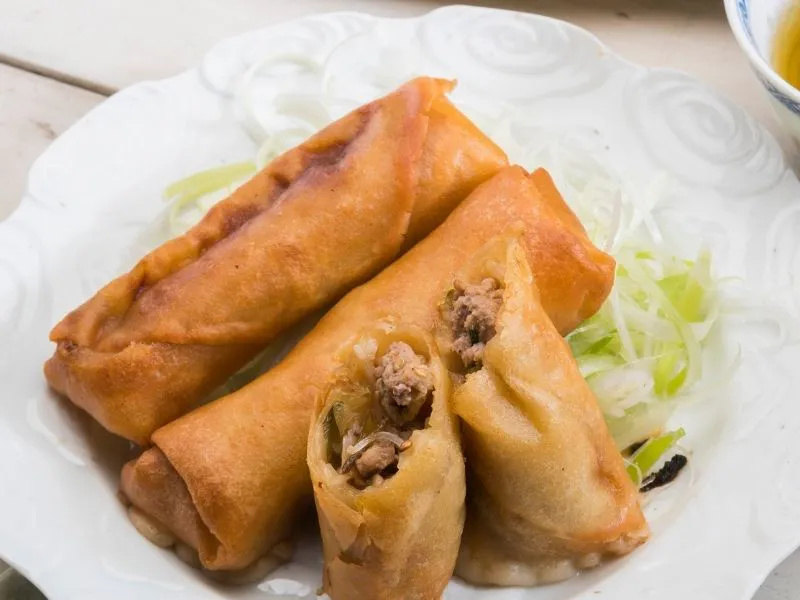 Crispy fried pork spring rolls served on decorative white plate at China Moon, a Chinese Restaurant in Twinsburg