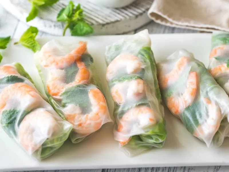 Fresh translucent shrimp summer rolls with herbs on white platter at China Moon, a Chinese Restaurant in Twinsburg