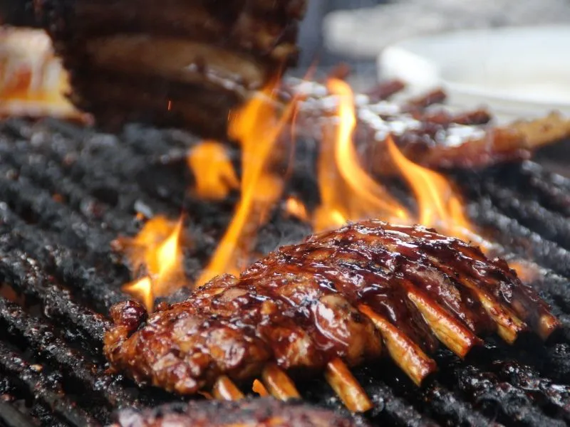 Glazed barbecue ribs cooking over open grill flames at China Moon, a Chinese Restaurant in Twinsburg