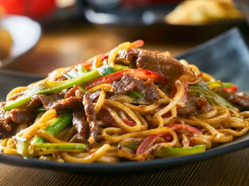 Savory beef stir‑fried noodles mixed with bell peppers and scallions at China Moon, a Chinese Restaurant in Twinsburg